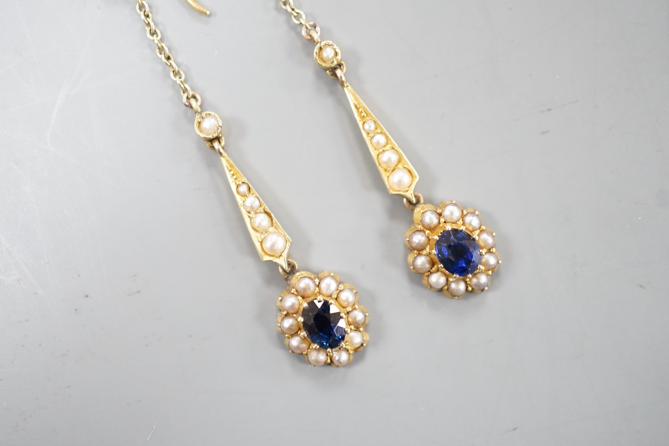 A pair of yellow metal, sapphire and seed pearl set drop earrings. 41mm, gross weight 3.4 grams.